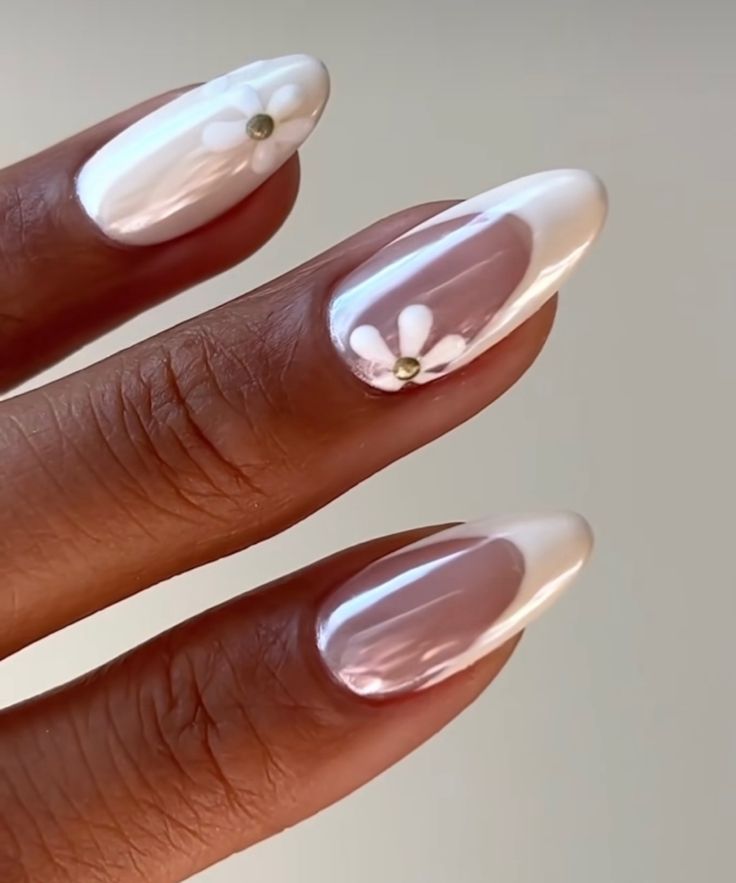 Chic Almond-Shaped Nail Design with Glossy White Finish and Elegant Floral Accents.