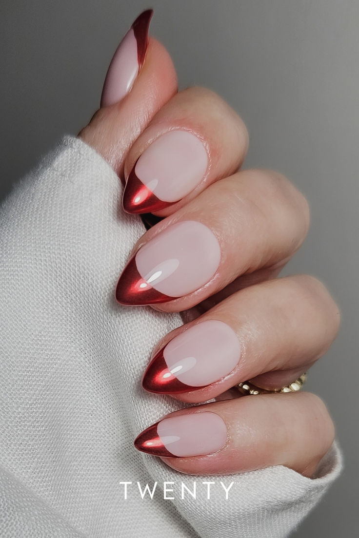 Chic Almond-Shaped Nails: Elegant Nude Base with Bold Red Tips for a Modern French Manicure.