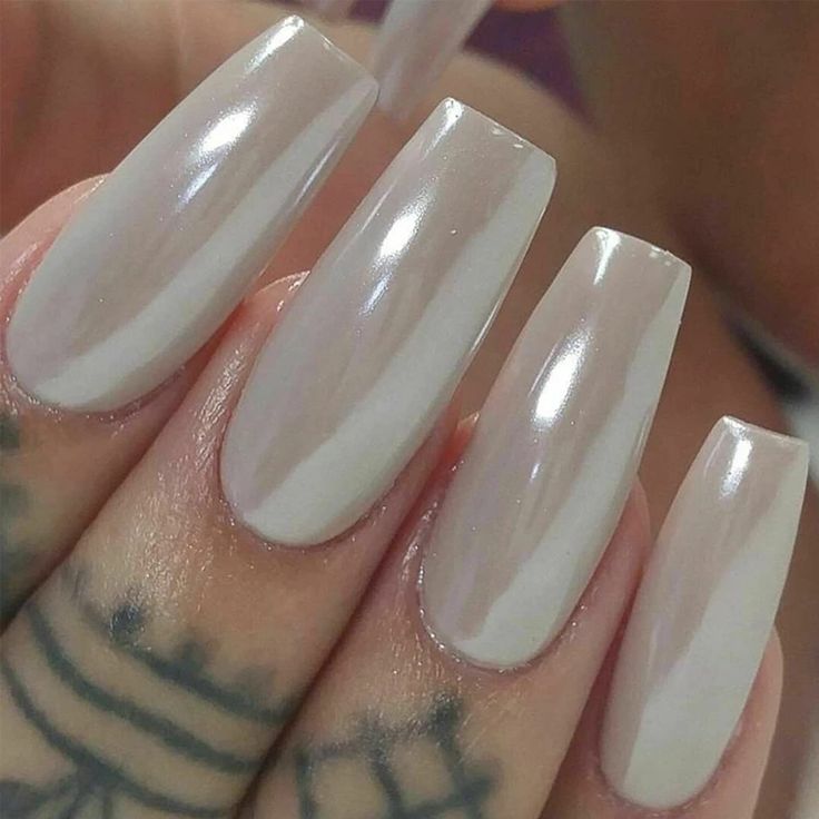 Chic Glossy Nude Long Nails with Iridescent Glow and Sophisticated White Accents.