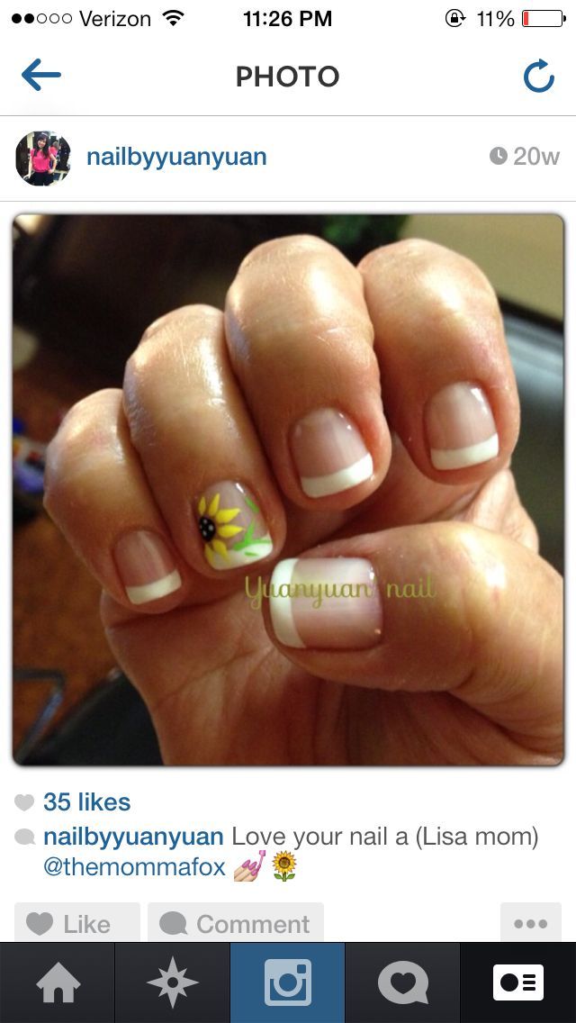 Elegant French Manicure with Playful Floral Accents and Vibrant Sunflower Design