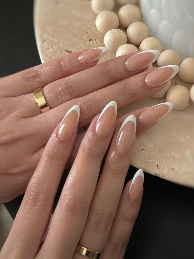 Chic French Tip Almond Nails with Glossy Finish and Gold Accents