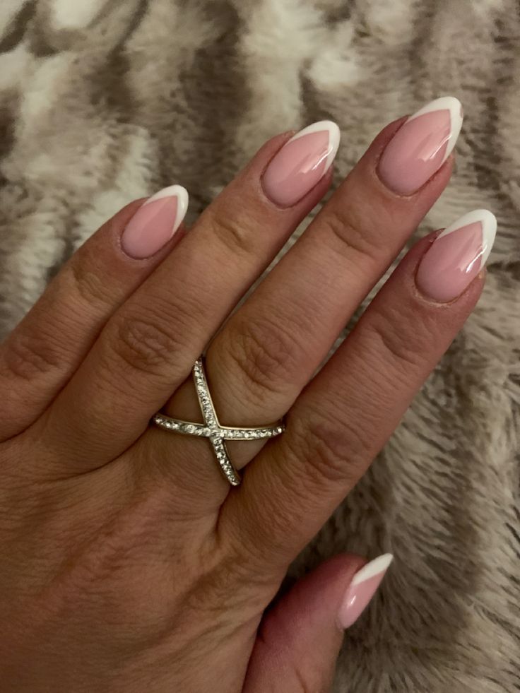 Chic French Manicure: Soft Pink Base with Sharp White Tips and Delicate Sparkling Ring.