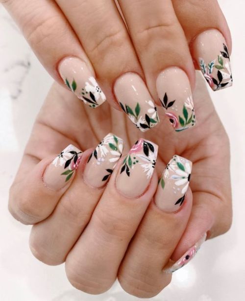 Elegant Floral Nail Design with Intricate Patterns on a Soft Nude Base.