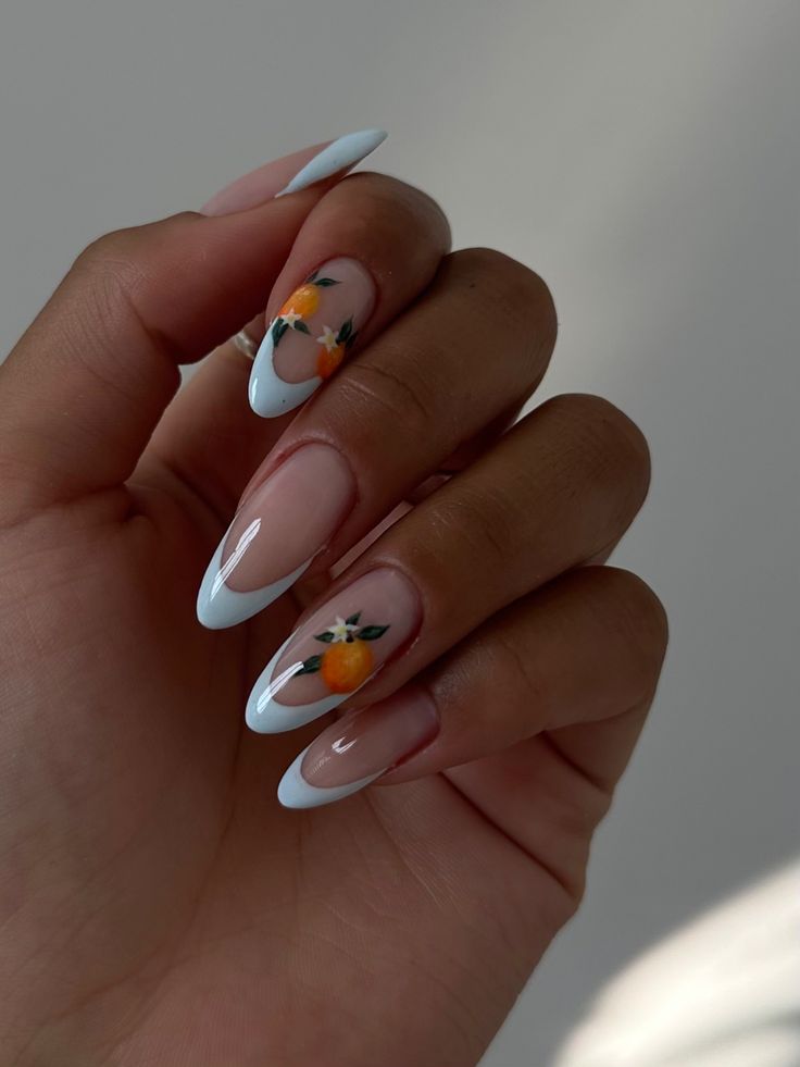 Elegant Modern French Tip Nail Design with Soft Blue Finish and Floral Artwork.