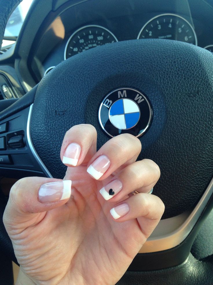 Chic French Manicure with Playful Black Heart Accent