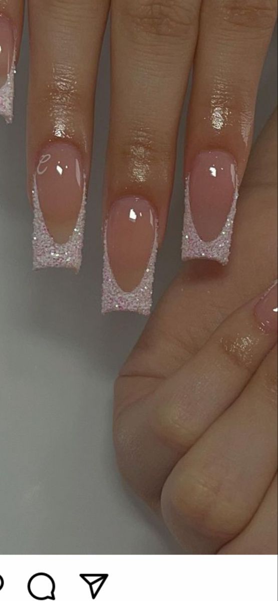 Elegant Ombre Glitter Tips: Soft Pink Base with Shimmering Transition.