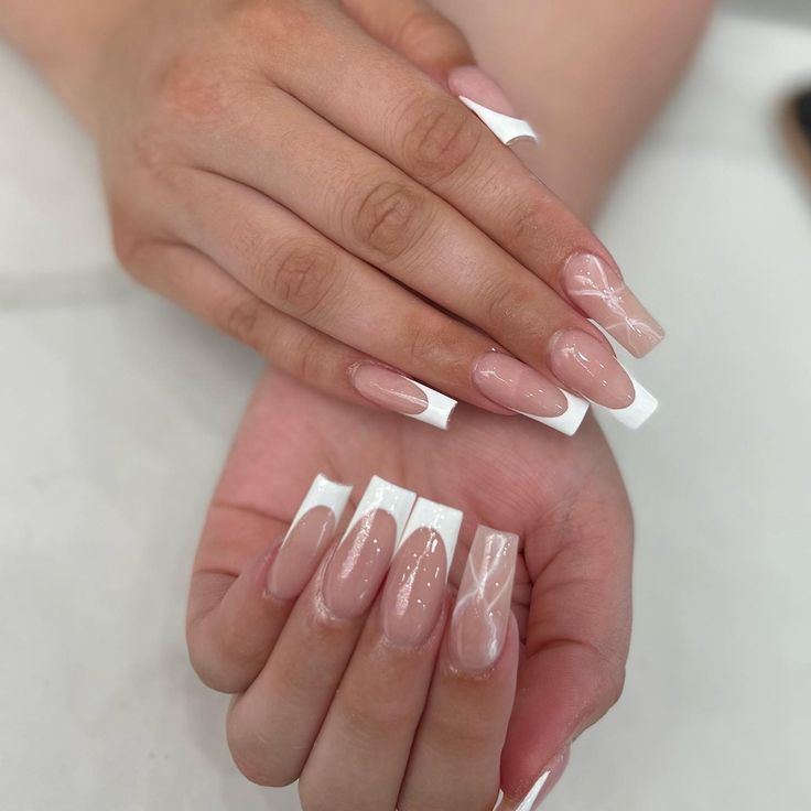 Sophisticated Long Almond Nail Design with Soft Nude and Striking White Accents.