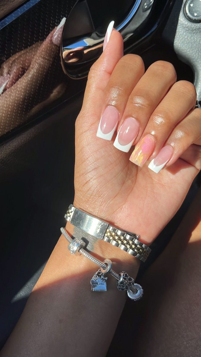 Chic Long Glossy French Manicure with Abstract Pastel Accent and Silver Bracelet Accents.