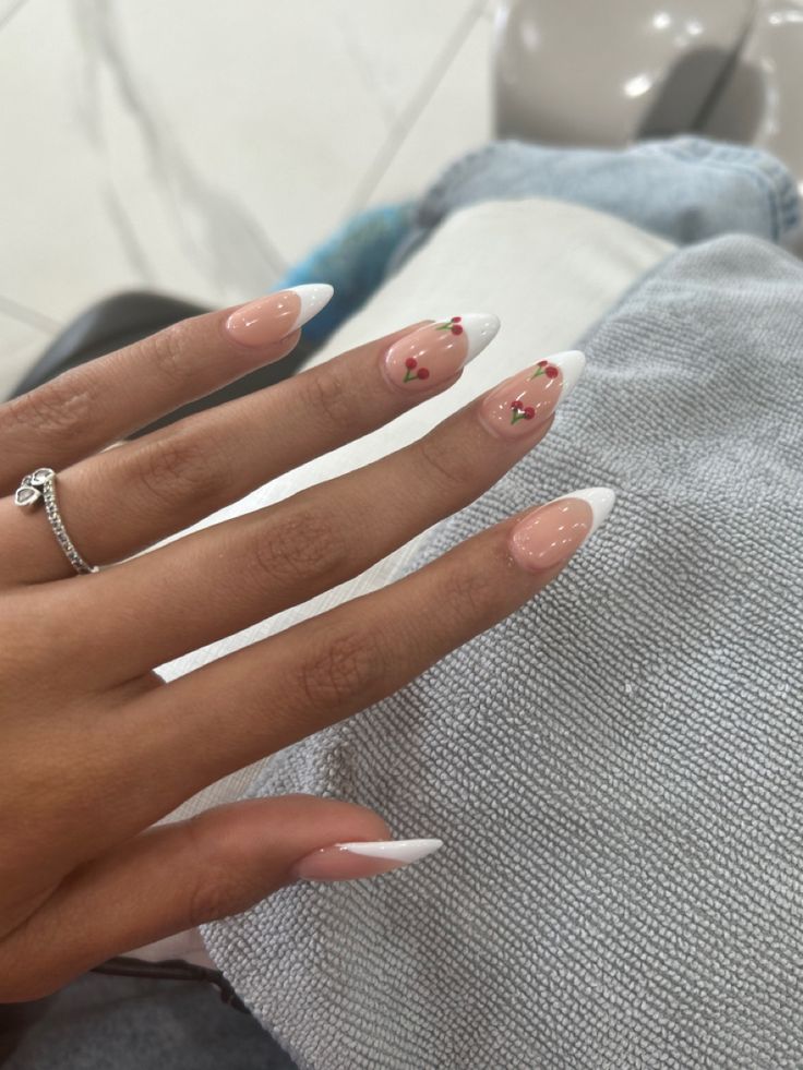 Sophisticated Nude and White Tip Nail Design with Delicate Floral Accents.