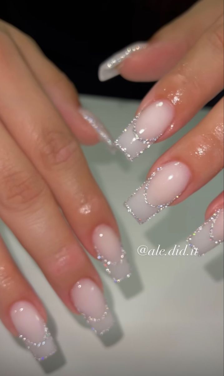 Sophisticated Sheer Pink and French Tip Nail Design with Rhinestones for Glamorous Looks.