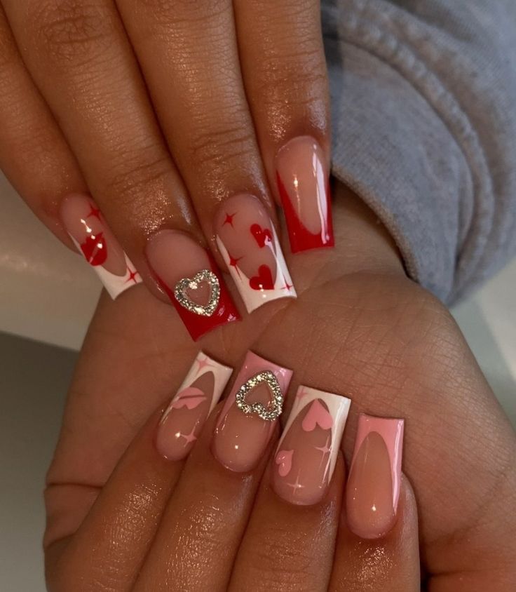 Festive Nail Design: Romantic Red, Pink, and White with Shimmering Silver Hearts and Playful Patterns