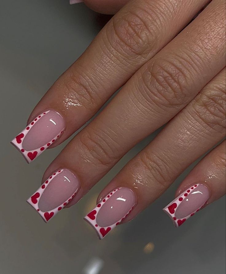 Charming Romantic Nail Design with Soft Pink, White Accents, and Bold Red Hearts.