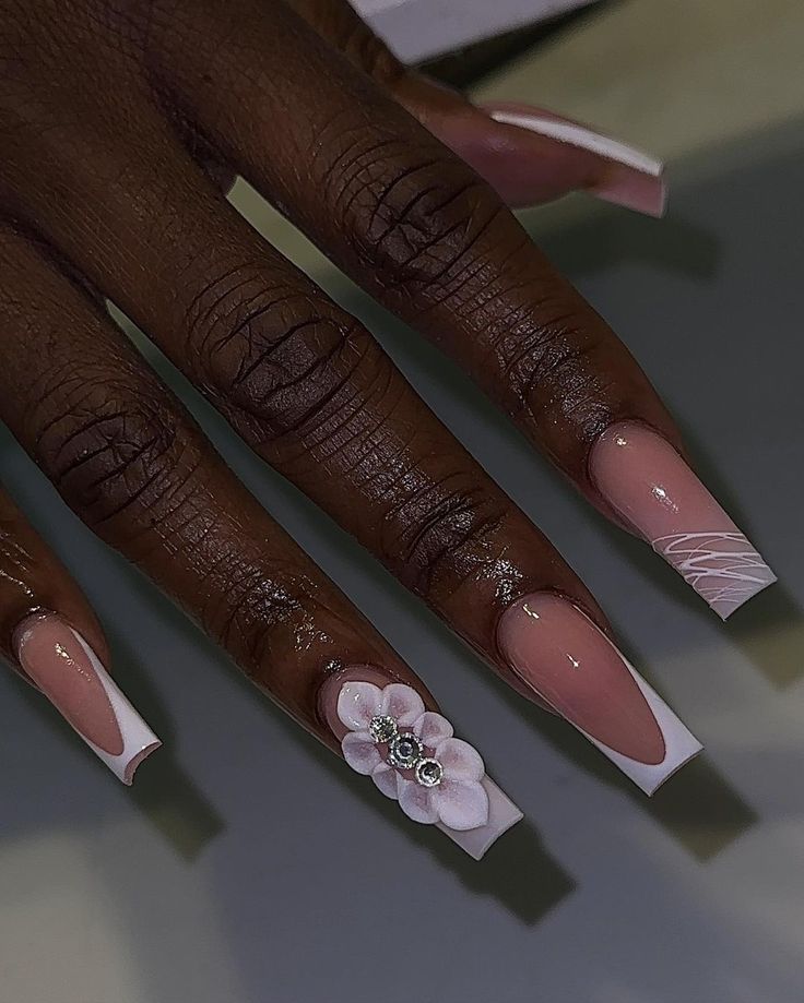 Chic Nail Design: Soft Nude Base with French Tips and Floral Accents