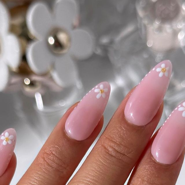 Charming Pastel Pink Manicure with Floral Designs and Golden Accents.