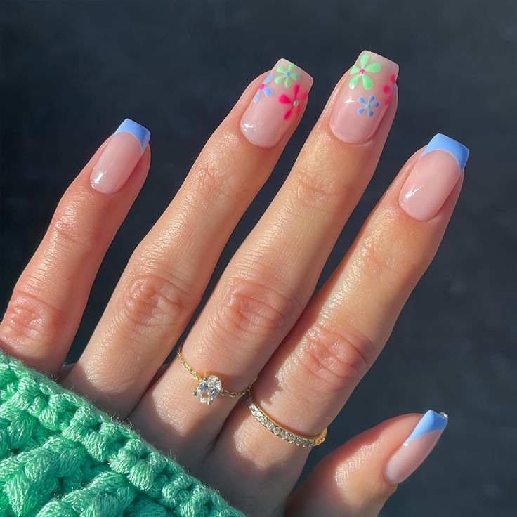 Vibrant Floral Nail Design with Playful Blue Tips for a Cheerful Summer Look.