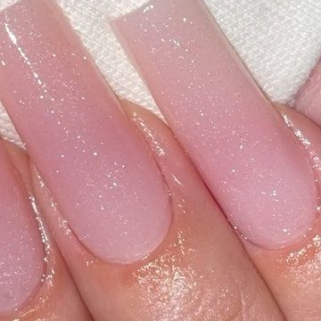 Delicate Shimmering Soft Pink Nail Design with Gradient Effect for Sophisticated Elegance.