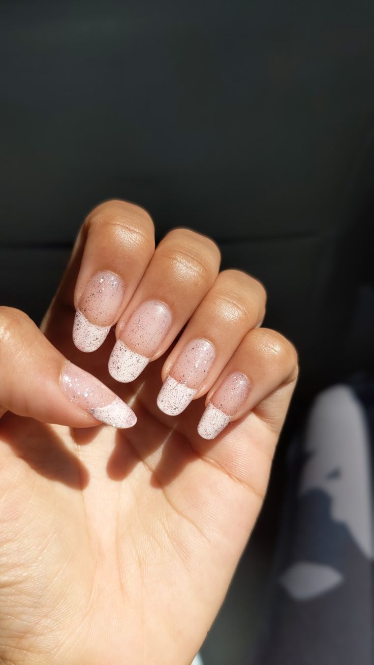 Sophisticated Gradient Nail Design with Sheer Nude Base and Sparkling White Tips.