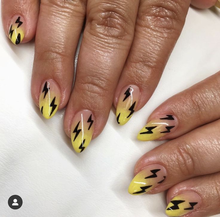 Bold Yellow and Black Lightning Bolt Nail Design for an Edgy Style.