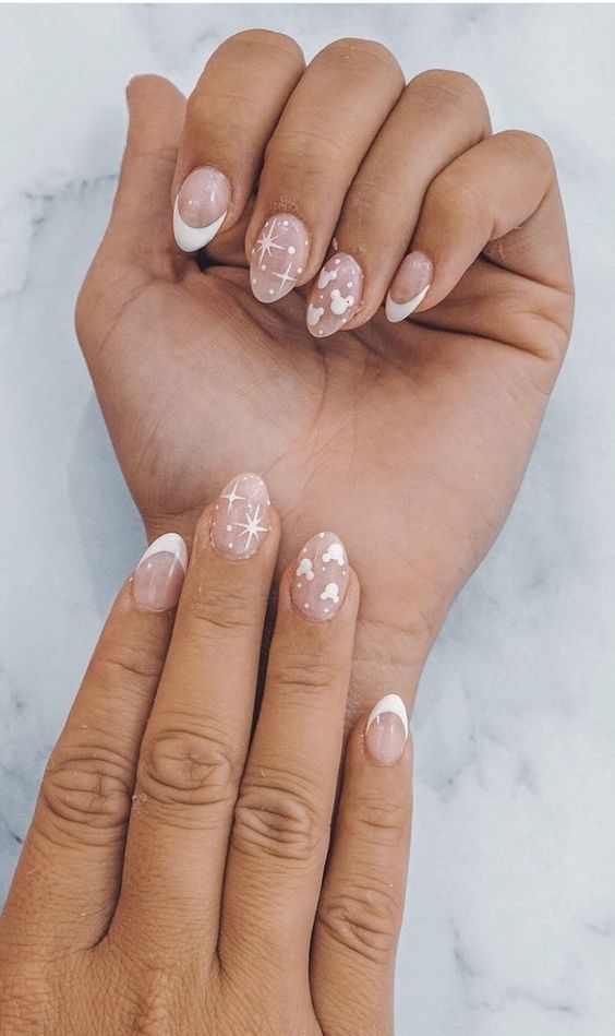 Chic and Whimsical Soft Pink Nail Design with Playful Accents and Heart Patterns