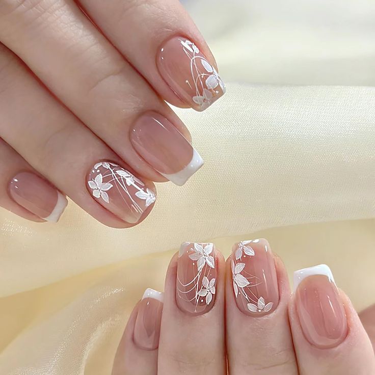 Sophisticated Floral Nail Design with French Tips on Soft Nude Base