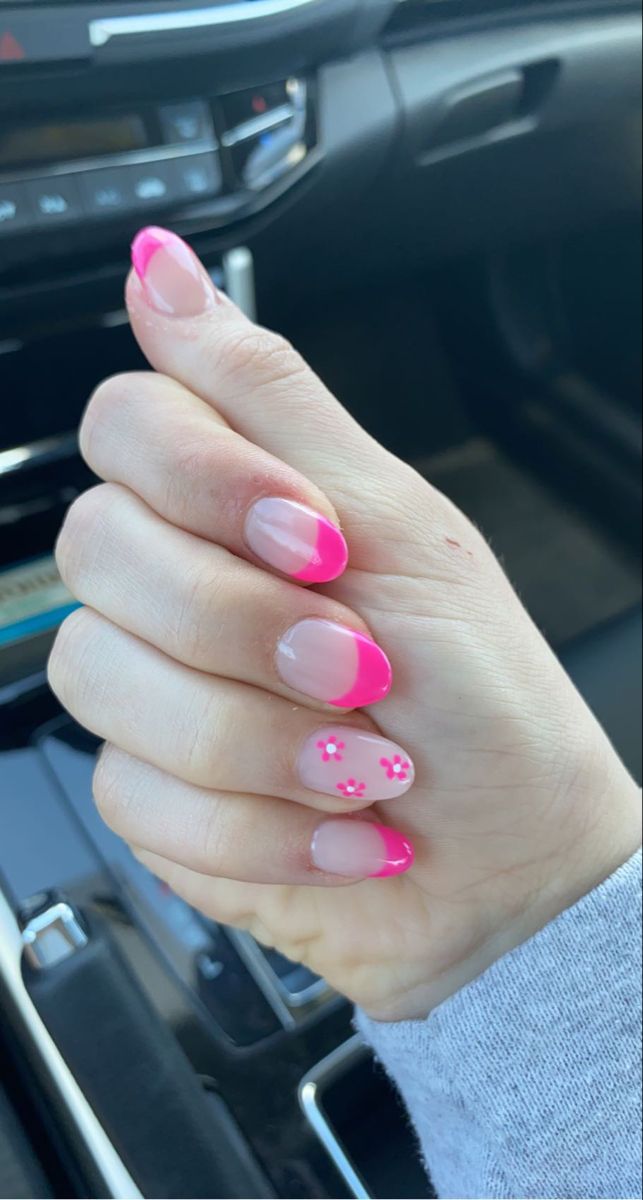 Vibrant Pink French Tip Manicure with Floral Accents for a Playful Elegance.