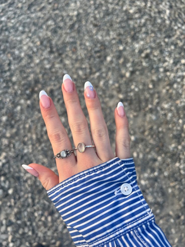 Refined French Manicure with Soft Pink Base, Classic White Tips, and Casual Sophistication in Blue and White Stripes.