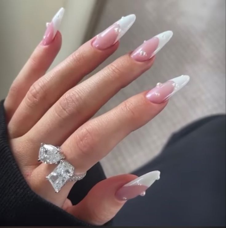 Sophisticated French Manicure: Soft Pink and Glossy White Tips with Gem Adornments.