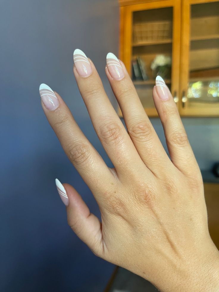 Chic Nude Almond Nails with Subtle White Stripes: A Perfect Blend of Elegance and Minimalism