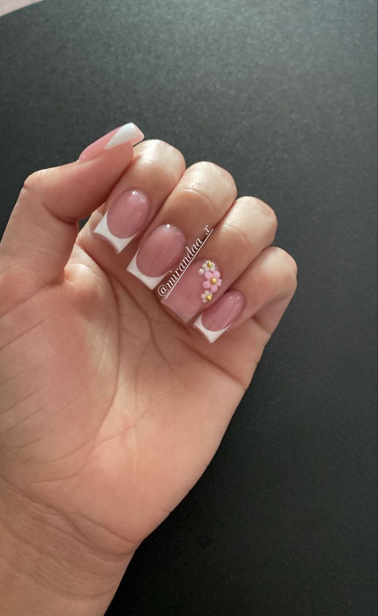 Chic Soft Pink Nail Design with White French Tips and Colorful Floral Accents.