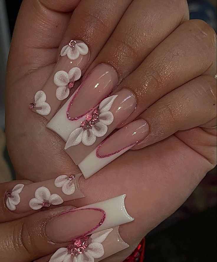 Elegant Floral Nail Design with White Flowers on Soft Pink Base.