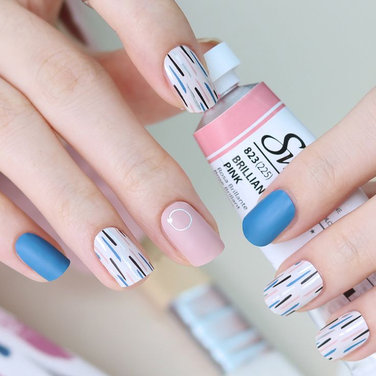 Pastel Geometric Nail Design with Blue Matte and Playful Accents.