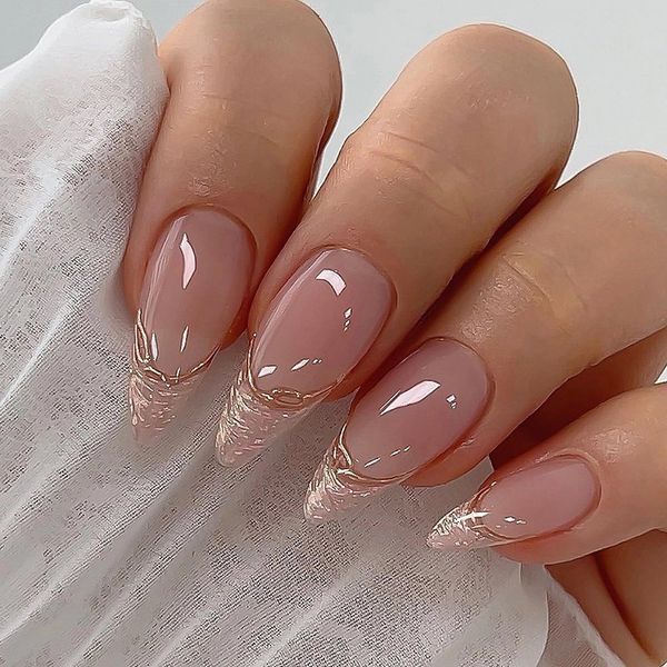 Sophisticated Almond-Shaped Nails with Glossy Nude Base and Artistic White Tips