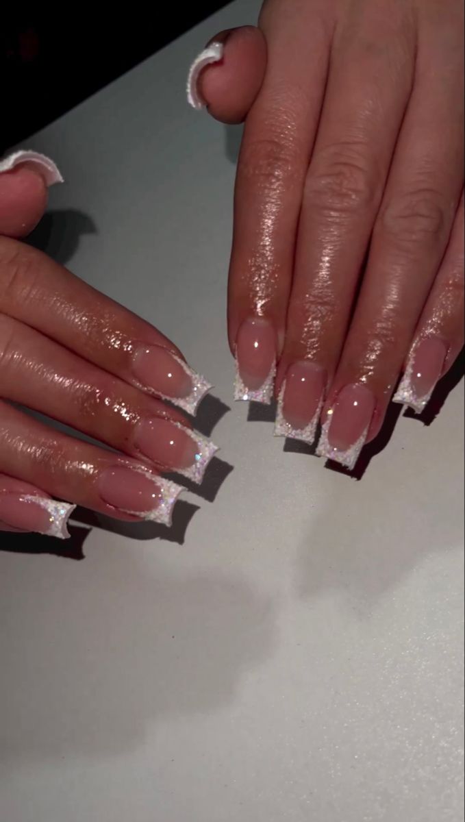 Glamorous Nude Nail Design with White Tips and Sparkling Accents