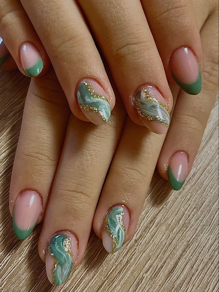 Chic Pastel Pink and Deep Green Nail Design with Marbled Patterns and Gold Accents.