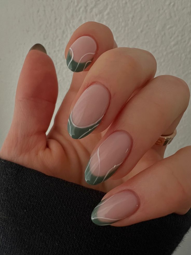 Chic Nude Nails with Green French Tips and Delicate White Accents.