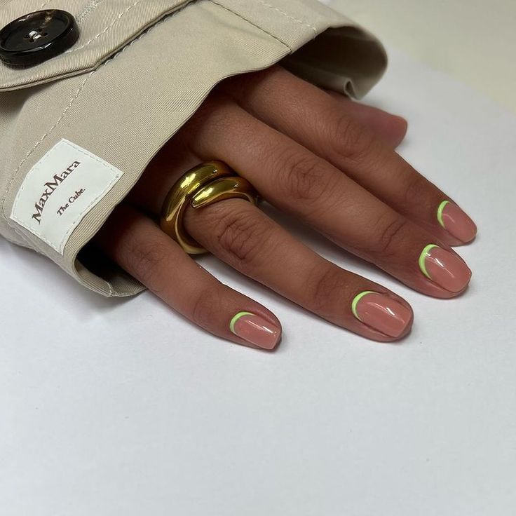 Elegant Chic Nail Design: Minimalist Nude Base with Neon Green Tips and Gold Accents.