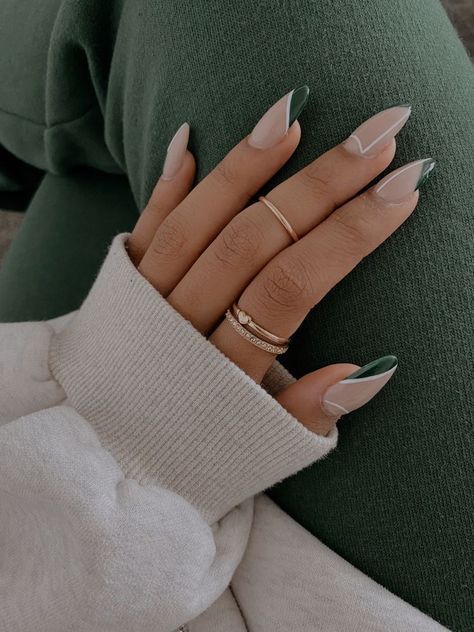 Chic Almond-Shaped Nails: Soft Nude Base with Dark Green Accents and Minimalistic White Lines.