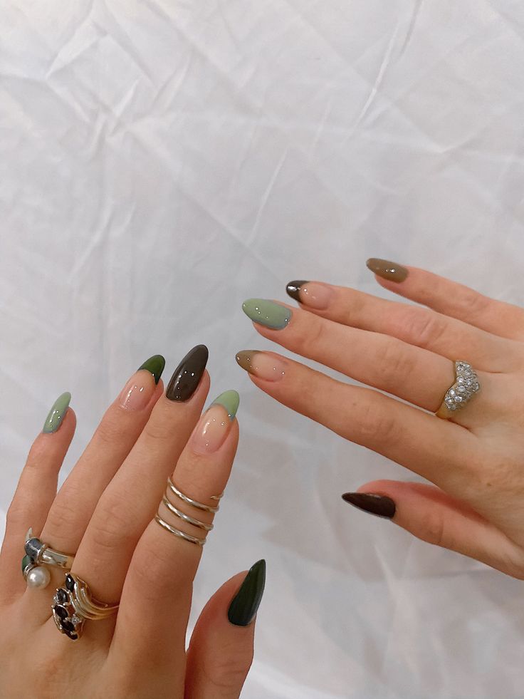 Trendy Earthy-Toned Nail Design with Glossy Finishes and Pointed Shape.