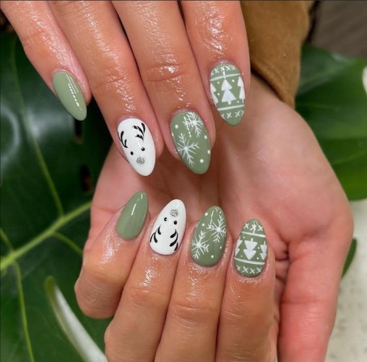 Festive Nail Design: Soft Green and White with Reindeer, Snowflakes, and Christmas Trees