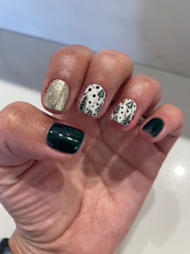 Sophisticated Nail Design: Deep Green and Gold Accents with Botanical Patterns.