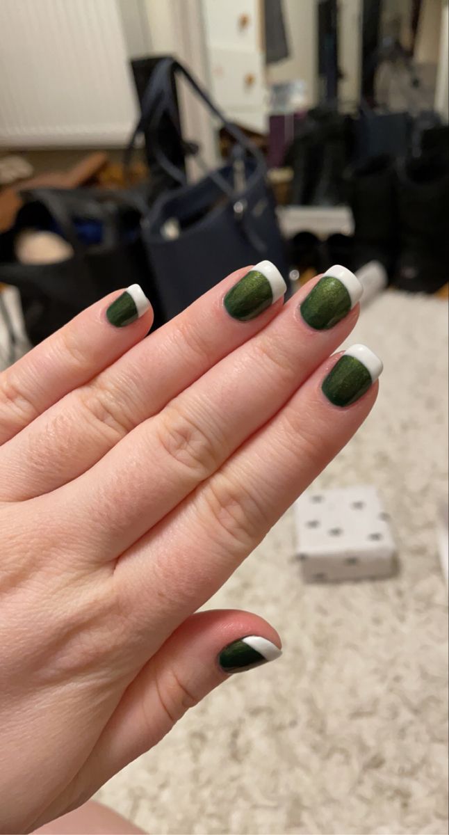 Sophisticated Deep Green Nail Design with Glossy Finish and White Tip Accents.