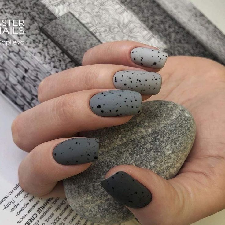 Chic Monochrome Matte Gray Gradient Nail Design with Textured Speckled Patterns.