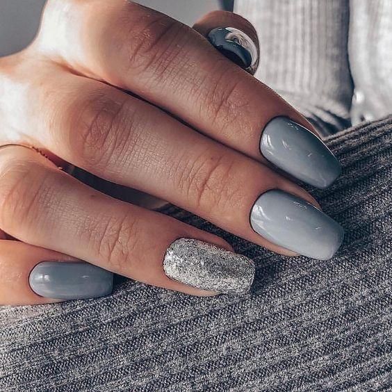 Sophisticated Nail Design: Muted Gray Palette with Stunning Silver Accent.