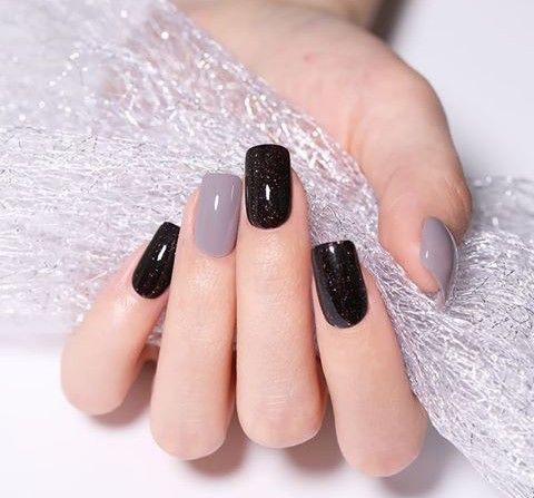 Elegant Matte and Glitter Nail Design in Soft Gray and Deep Black.