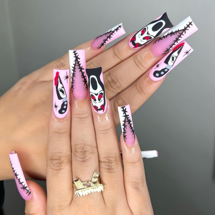 Playful Elongated Nail Design: Pink and Black Clown Faces for a Bold Statement.