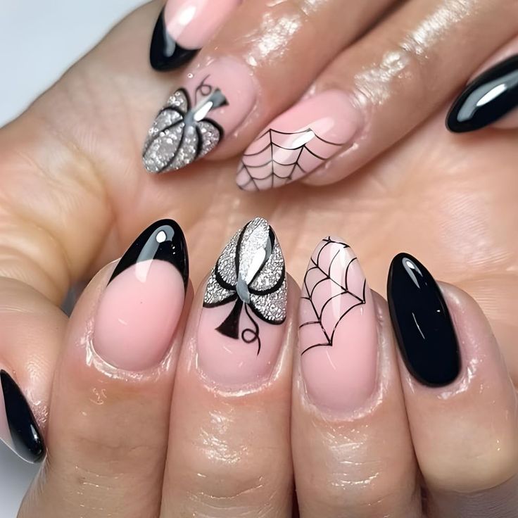 Chic Elegant Nail Design: Glossy Black & Soft Nude with Intricate Patterns and Whimsical Motifs.