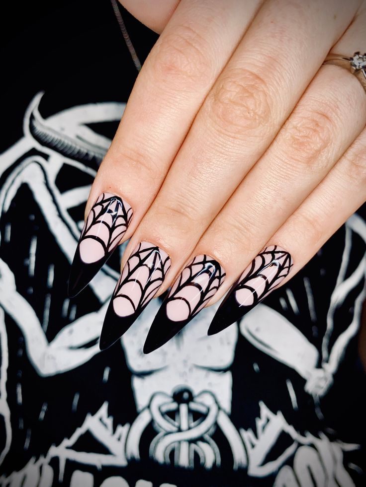 Gothic Glam: Black Stiletto Nails with Spiderweb Patterns for a Bold Halloween Statement