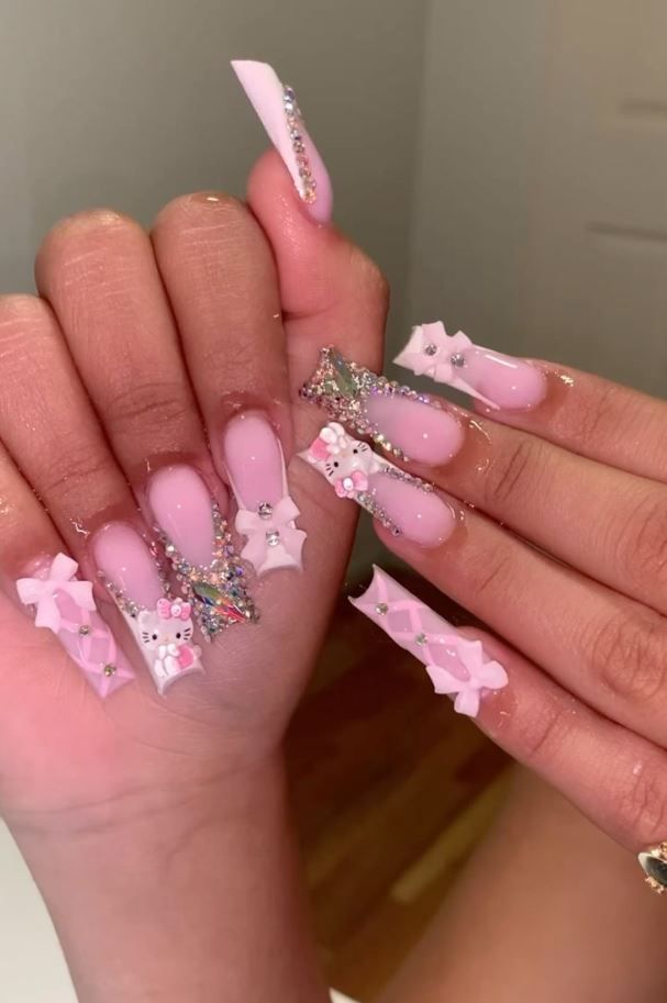 Whimsical Glamour: Elegant Pink Nail Art with Bows and Rhinestones.