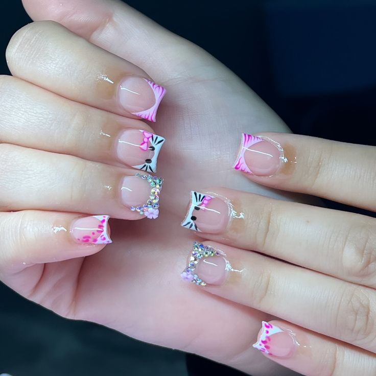 Chic Pink and Black French Manicure with Elegant Lines and Sparkling Embellishments.