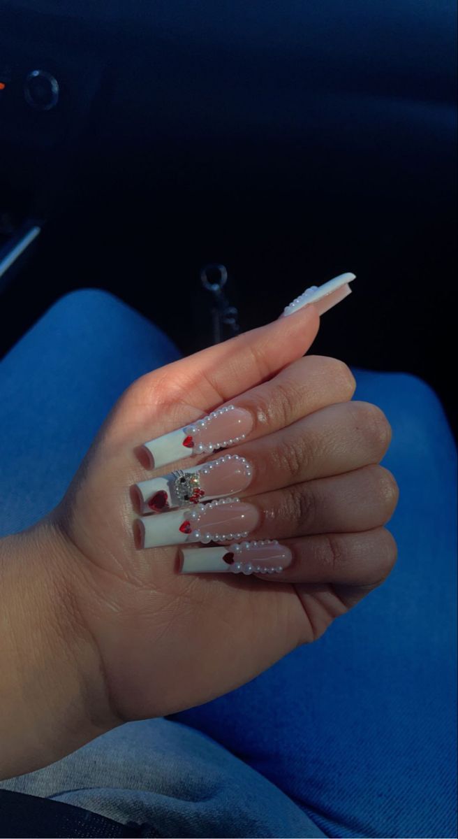 Sophisticated Nail Design with Soft Nude, Glossy White, Pearls, and Romantic Red Hearts